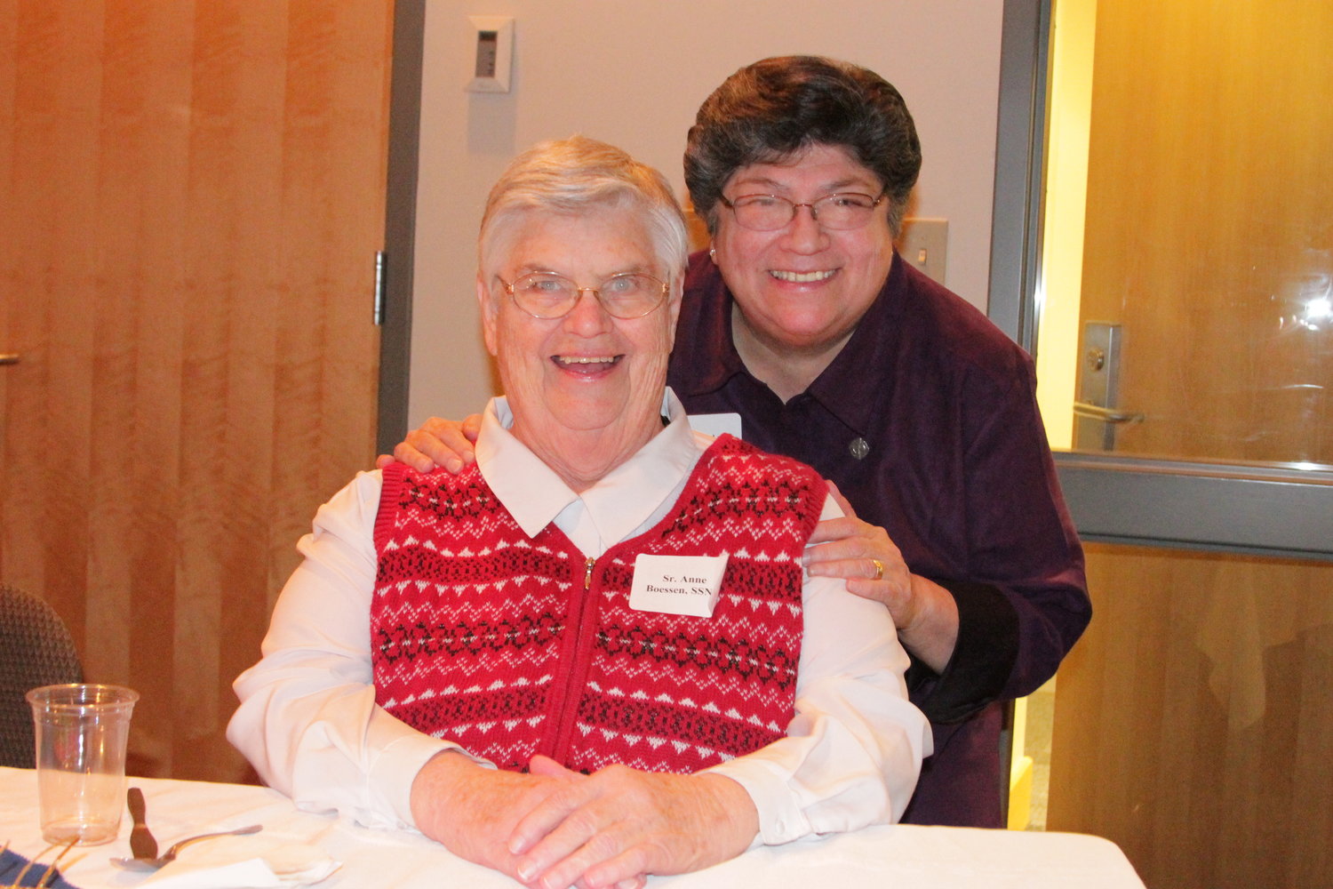 Sister Anne Boessen SSND, seated, and Sister Celly Ann Amparano, now deceased, enjoy a laugh in this file photo from the Jefferson City Diocese’s 2014 World Day of Consecrated Life celebration.